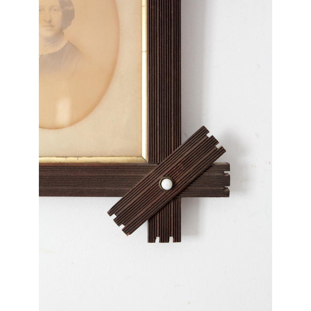 This antique Victorian folk art frame showcases handcrafted charm with its geometric design and porcelain dot accents,...