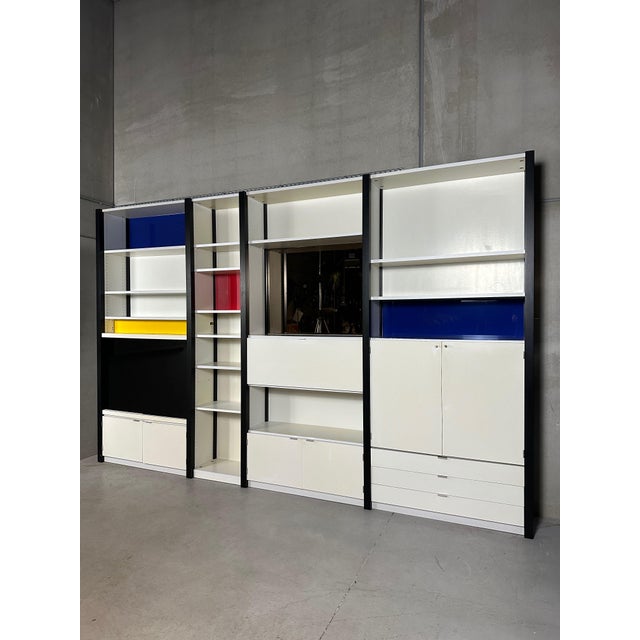 A strikingly sleek modular wall cabinet of German quality. Black, sleek, sturdy beams interspersed with white shelves. The...