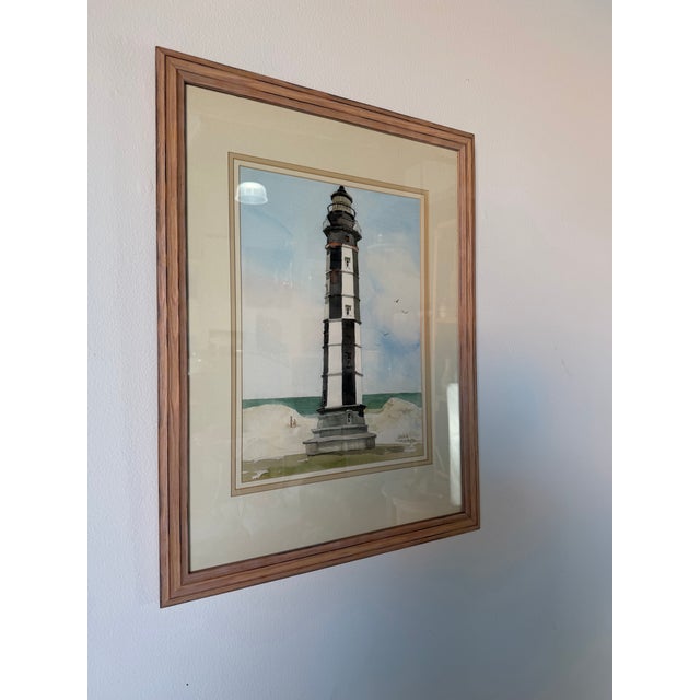 Beautiful 1990’s watercolor painting by Joanna Krasnansky featuring a striking coastal lighthouse landscape with soft...