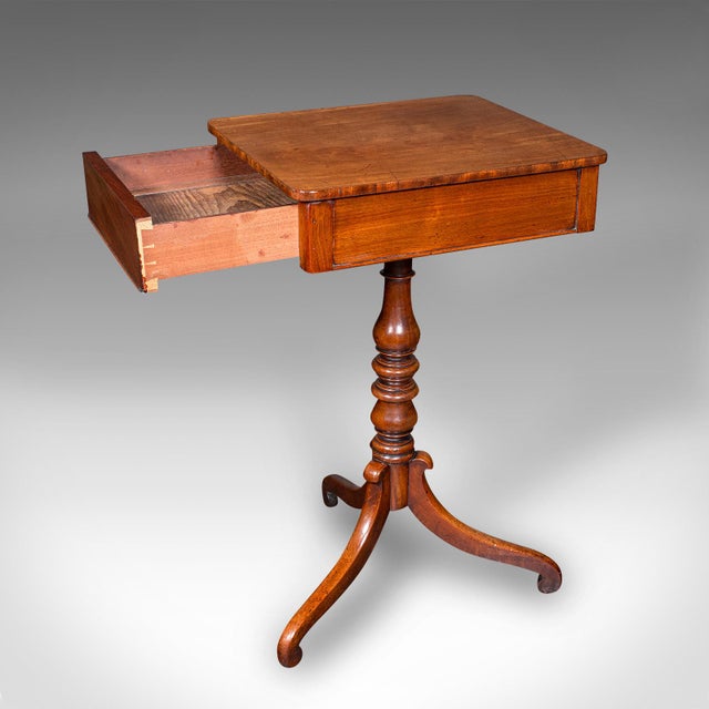 This is a small antique wine table. An English, mahogany side table with concealed drawer, dating to the Regency period,...