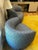 This Ligne Roset blue fabric armchair features a rounded, low-profile lounge shape with curved arms and a fully...