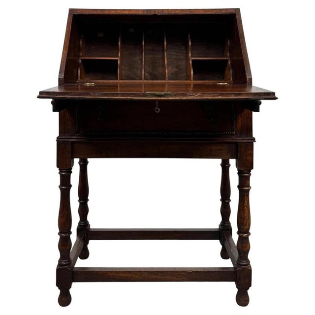 An exceptionally well-crafted early 20th-century English bureau in the Jacobean style, finely constructed in oak and...