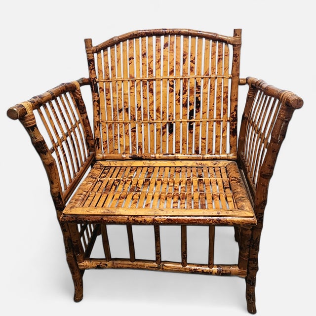 Authentic vintage bamboo lounge armchair crafted from real bamboo with an architectural arched back, open spindle sides,...