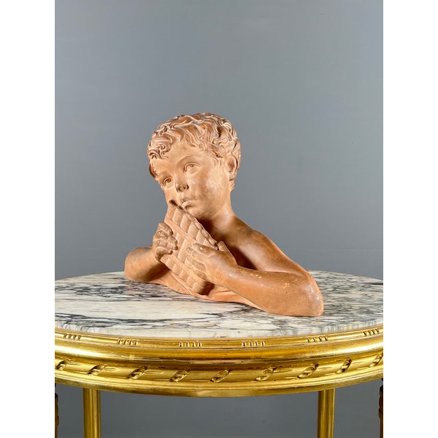 Terracotta bust of a child signed d. H. Chiparus a superb terracotta bust depicting a young child holding a panpipe, a...