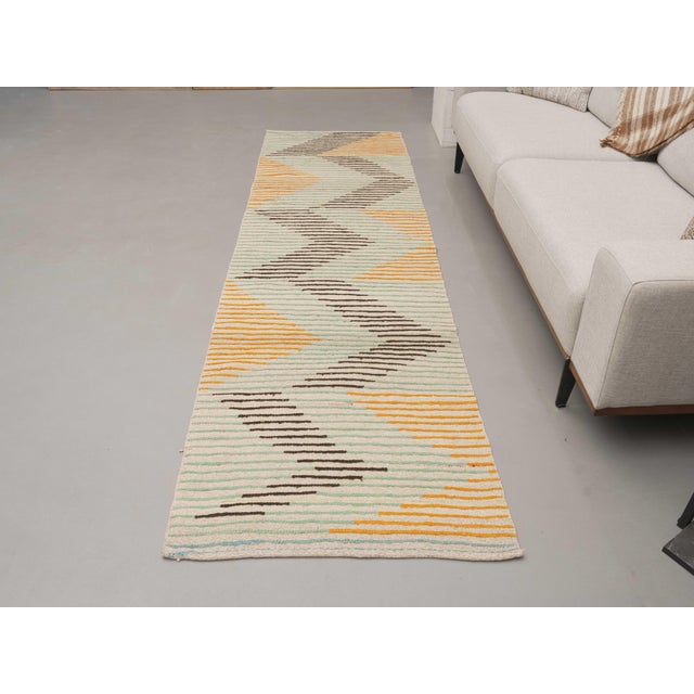 Vintage Hand-Knotted runner rug is a semi-antique vintage area rug. The '70s Eastern region of Anatolia's unique rug is...