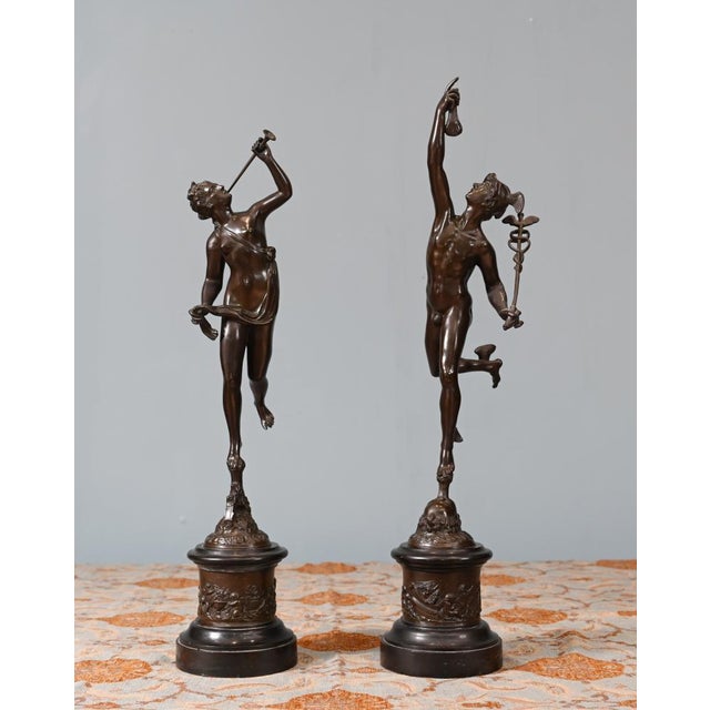 A pair of antique Italian bronze statues depicting Mercury and Victory The statues are circa 1880 and signed by the artist...