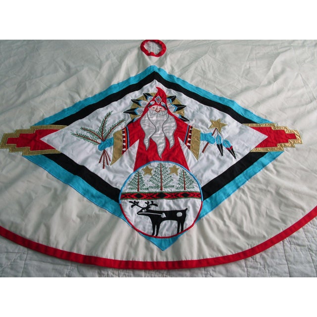 This vintage tree skirt tells a story of artistry and heritage, showcasing a vibrant applique Southwest Santa design....