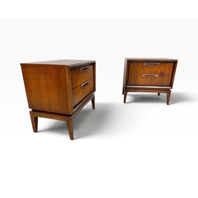 A beautiful pair of Mid-Century Modern Broyhill walnut nightstands, circa 1960s, showcasing classic American modern design...