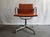 EA 108 swivel, one with armrests, the other without, fabric with brick-colored padding. This piece has an attribution...