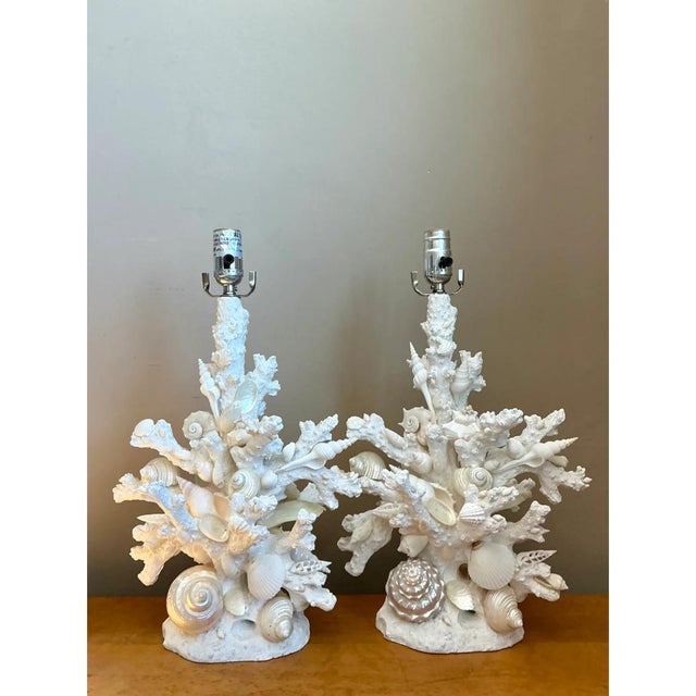 This pair of vintage table lamps pairs sculptural plaster forms with an array of natural shells — conch, spiral, and...