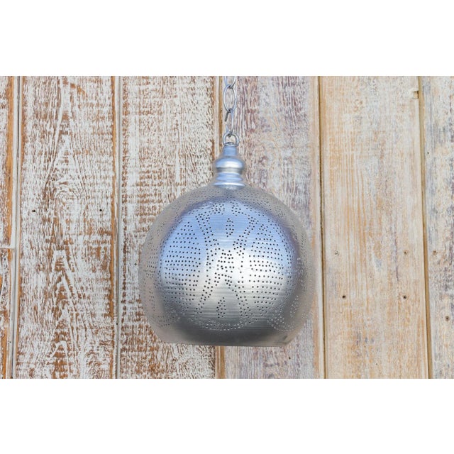 A delicately perforated Moorish pendant lantern. This pendant features pierced foliate see-through work which is all done...