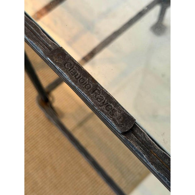 Exceptional matched pair of authentic Claudio Reyes hand-forged iron and glass side tables. Beautifully textured forged...
