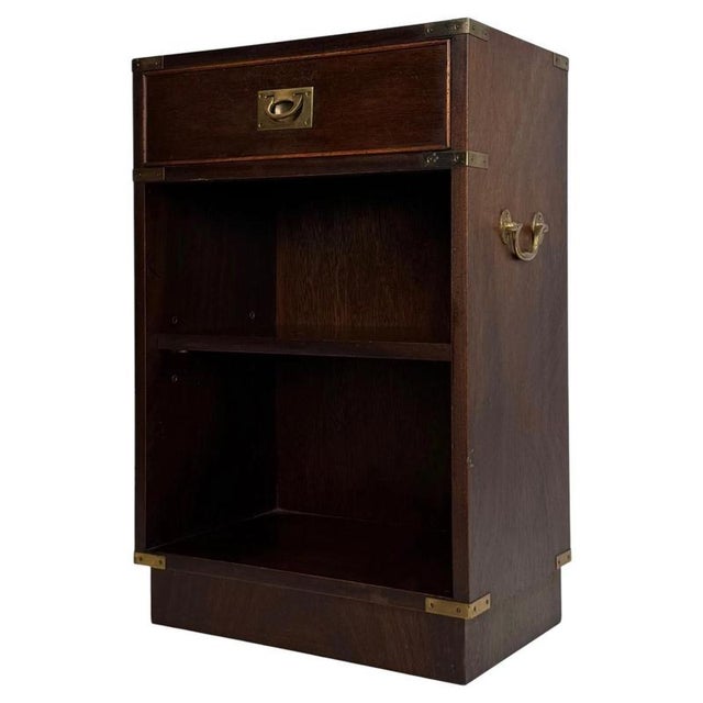 A handsome and distinctive early 20th-century English cabinet in the Campaign style, finely constructed in mahogany and...