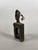 BAOULE, IVORY COAST. Loom pulley surmounted by an anthropomorphic head with a carved feline decoration at the top of the...