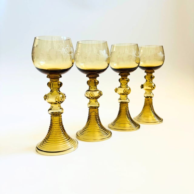 A set of 4 antique German roemer glasses. Clear glass bowls with an etched grape leaf design. Beautiful ribbed bases with...