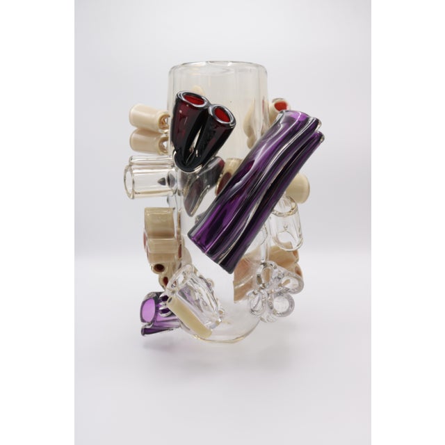 A Martin Potsch Contemporary Art glass vase. Clear vase with multi colored tubular prunts in purple, cream and clear....