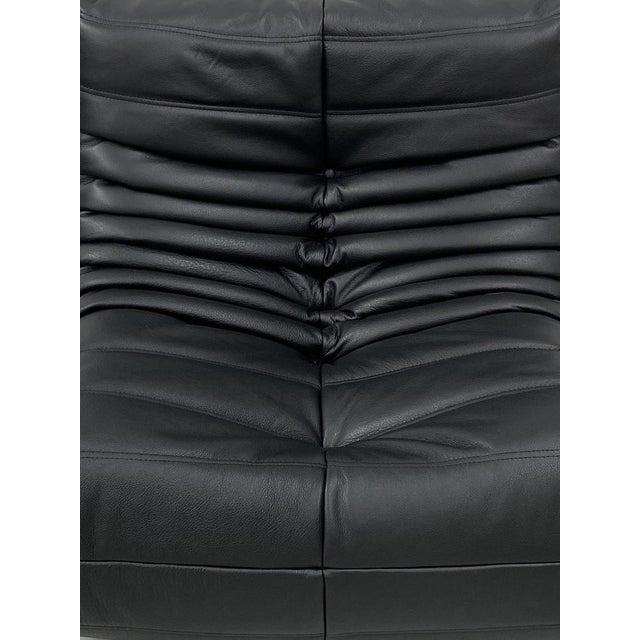 This Togo has been reupholstered with parts of new foam and leather, preserving its shape & iconic looks.The bottom could...