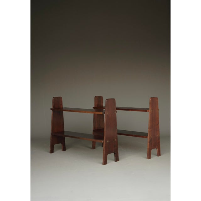 Pair of freestanding mid-century bookshelves. Circa 1950s. Constructed of rich coloured solid cherry wood with solid brass...