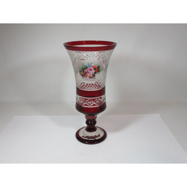 14 1/2" high cased Bohemian art glass pedestal vase. This flared vase has ruby bands separating clear cut glass diamond...