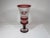 14 1/2" high cased Bohemian art glass pedestal vase. This flared vase has ruby bands separating clear cut glass diamond...