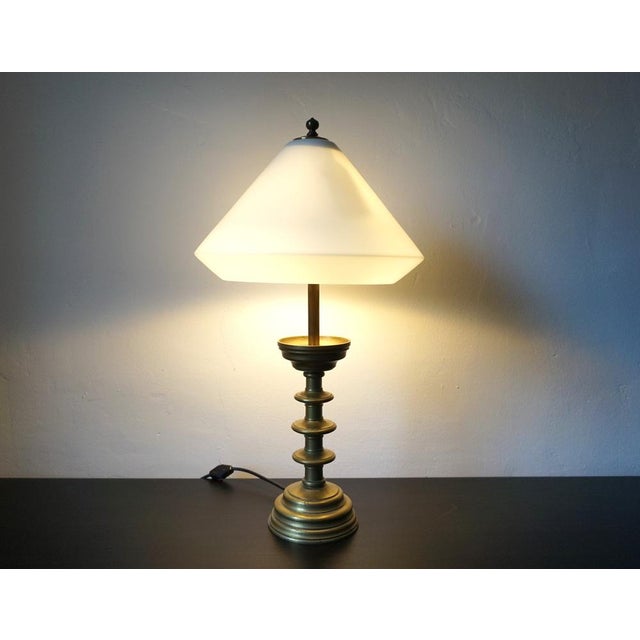 This probably proportioned table lamp made of solid brass comes in an excellent condition with a fantastically patinated...