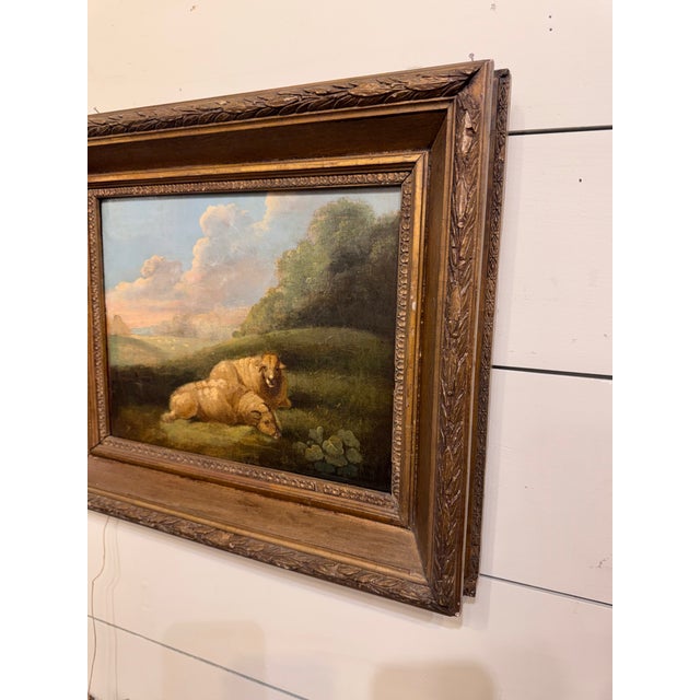 Oil painting on canvas depicting two sheep resting on a grassy bank. The painting portrays a tranquil, rural scene in the...