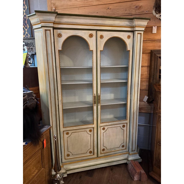 Beautiful painted cream color (with a blue undertone peeking thru) cabinet accented with earthy colors: olive green,...