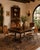 Elegant set of four Palma Brava dining chairs featuring sculptural wrought iron frames paired with rich brown leather...