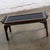Attractive vintage Chinese Chippendale petite coffee table composed of a walnut frame and a black glass inset top....