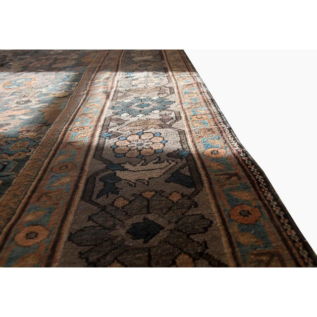 A late 19th century antique Persian Sultanabad rug, the abrashed blue and slate field with an allover stylized trellis of...