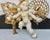 Gilt wings on an Ersatzputti. Pearls and jewels with tassels adorn a little Putti in mid-flight. Cast in an assembly held...