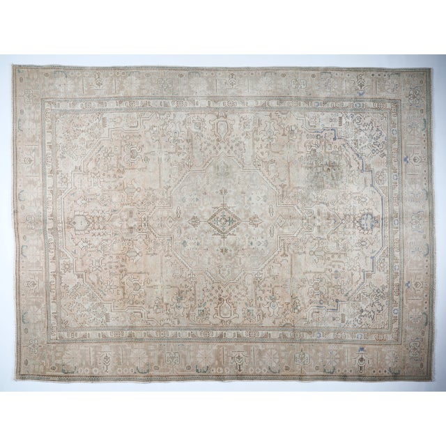 This beautiful vintage Persian Heriz rug features a serene, soft color palette of gentle beige, taupe, and subtle hints of...