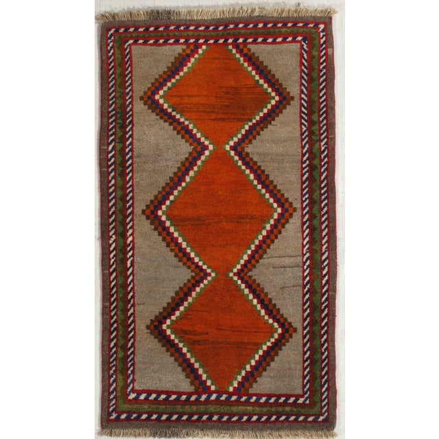 Vintage Persian Gabbeh hand-knotted wool rug with a neutral field and three stepped diamond medallions in orange tones,...