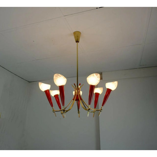 - Filigree hanging lamp from the 50s - The frame is made of brass - 7 arms with red plastic details - The shades are made...