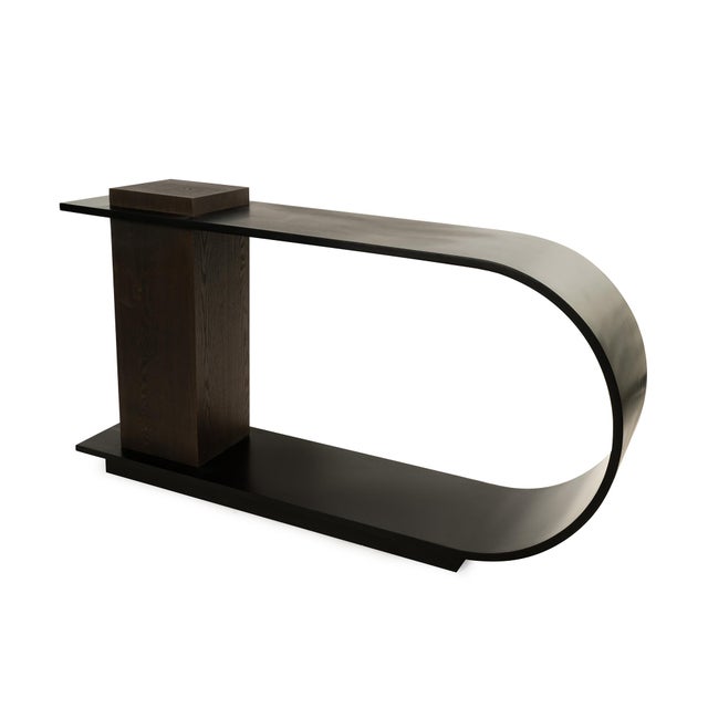 Strikingly sculptural and undeniably bold, the Obsidian Curve Table commands attention with its fluid, modern silhouette....