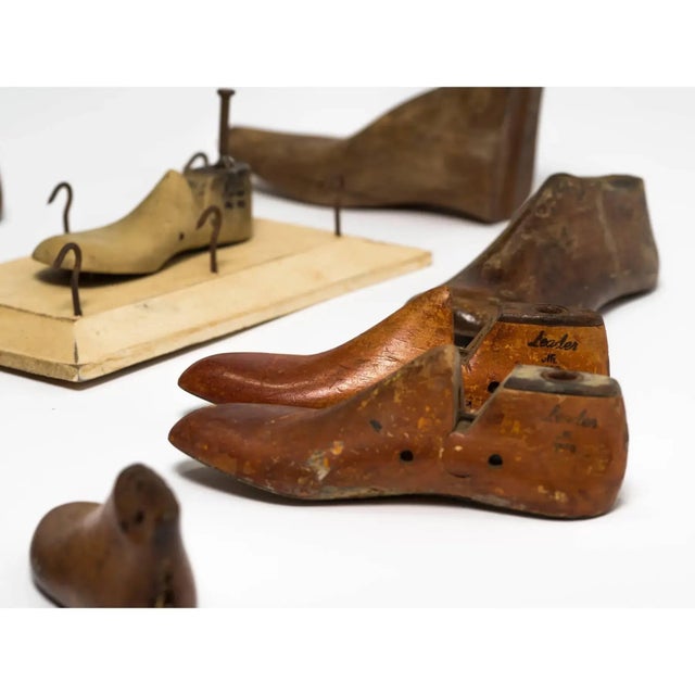 A collection of 17 antique French wooden children’s shoe molds ranging in tone from warm honey brown to reddish stained...