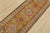 A tribal Caucasian Kazak runner hand-knotted with fine wool on a cotton foundation. This rug features a row of geometric...