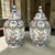 Graceful in form and richly detailed, this pair of Boch Frères Keramis lidded urns has remained in a private collection...
