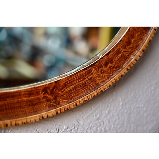 This beautiful oval mirror has a wooden frame enhanced with stucco. It is skillfully painted to resemble burl wood. It is...