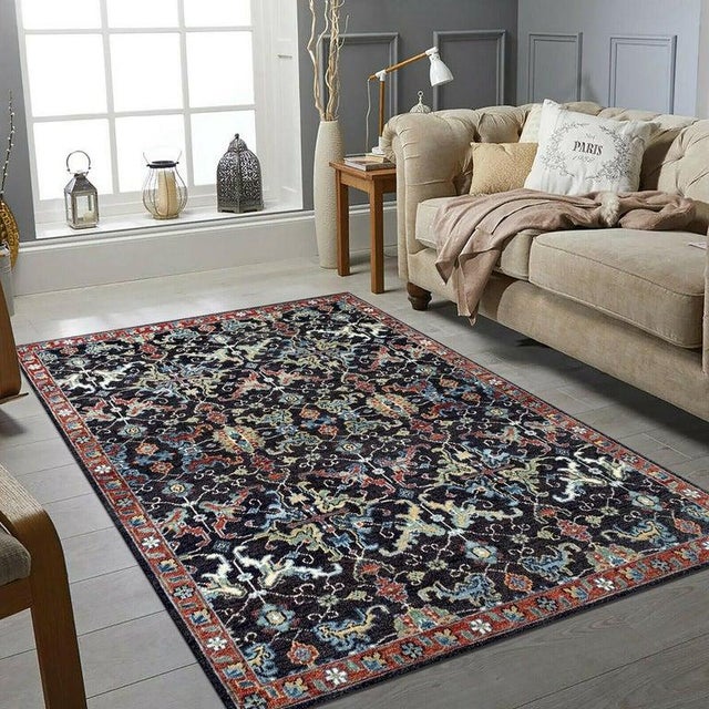 This blue wool rug features a hand knotted pile construction and originates from artisan weavers in India. It represents a...