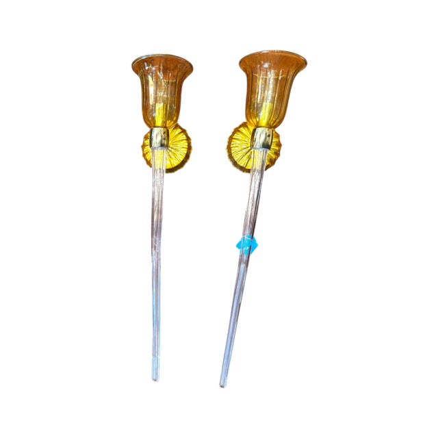 Elegant pair of Venetian-style wall sconces featuring hand-blown amber glass shades and sculptural clear glass stems. Each...