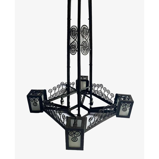 Antique, French Art Deco wrought iron pendant light in the style of Edgar Brandt. This artfully crafted piece has four...