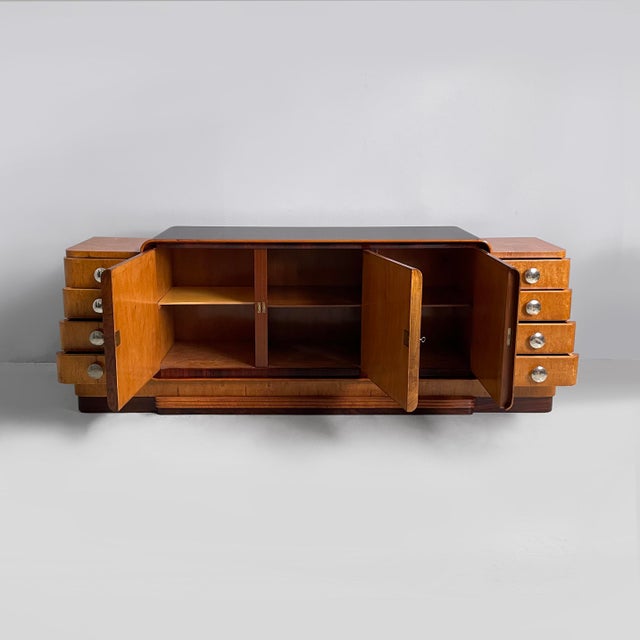 Italian Art Deco sideboard in wood and steel, 1930s. Rectangular sideboard with rounded profiles in light and dark wood....
