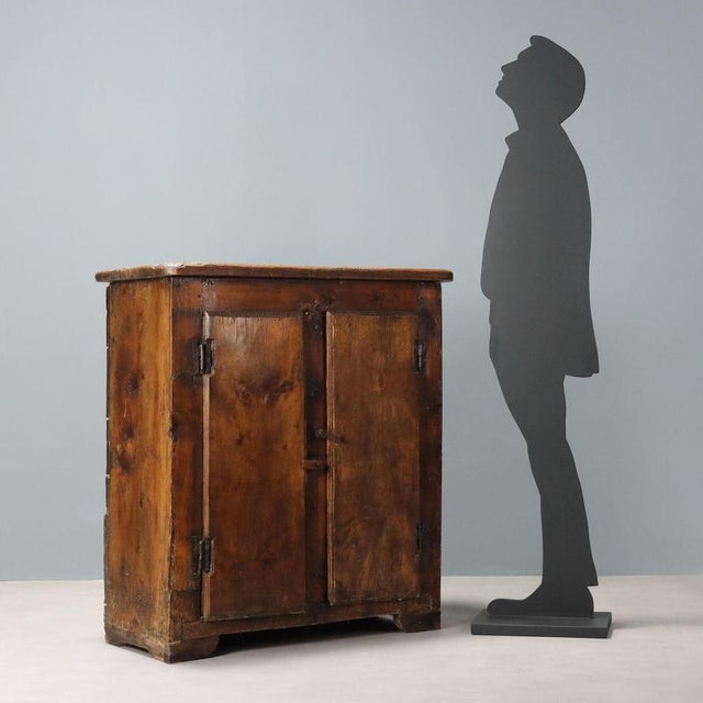 Sideboard in walnut-stained fir, two doors and central upright. Various restorations and replacements. Italy, 17th...