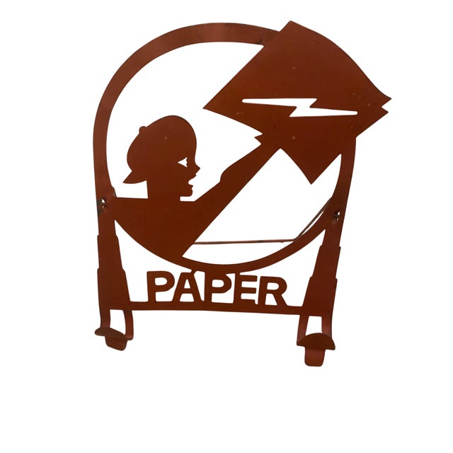 American Art Deco Machine Age Metal Paper Holder Depicting a Newsboy. This whimsical paper holder from circa 1930, at the...