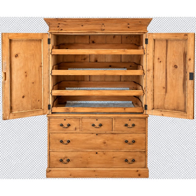 A handsome 19th-century English pine linen press, combining generous storage with beautifully restrained country-house...