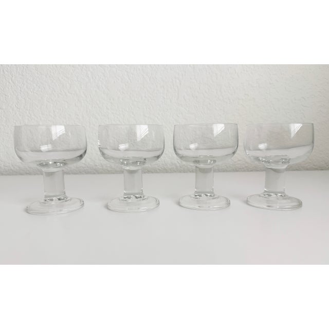 Set of four 1970s clear glass wine goblets with wide mouth and chunky stem. Marked France on bottom.