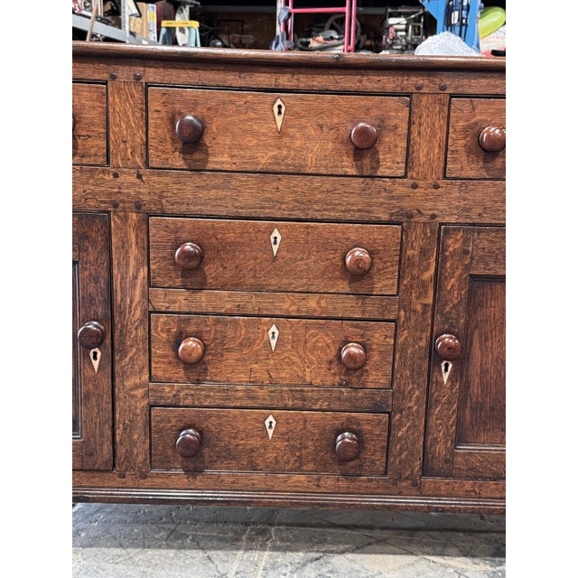 This is a beautiful 18th century English dresser base with original pulls, accompanied by lovely bone inlaid escutcheons...
