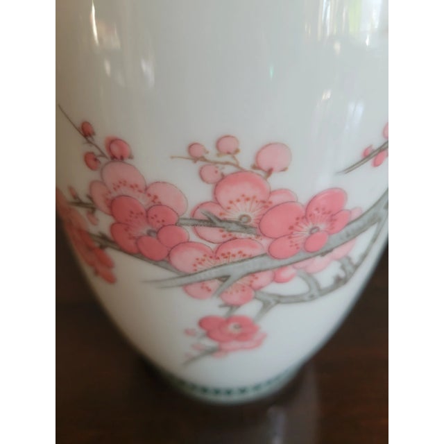 One of a kind fine porcelain, small vase with beautiful hand painted tridimentional, textured cherry blossoms motifs that...