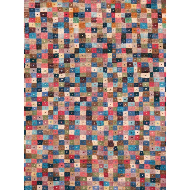 This mid-20th-century Persian Veece accent carpet presents a distinctive allover checkerboard composition filled with...